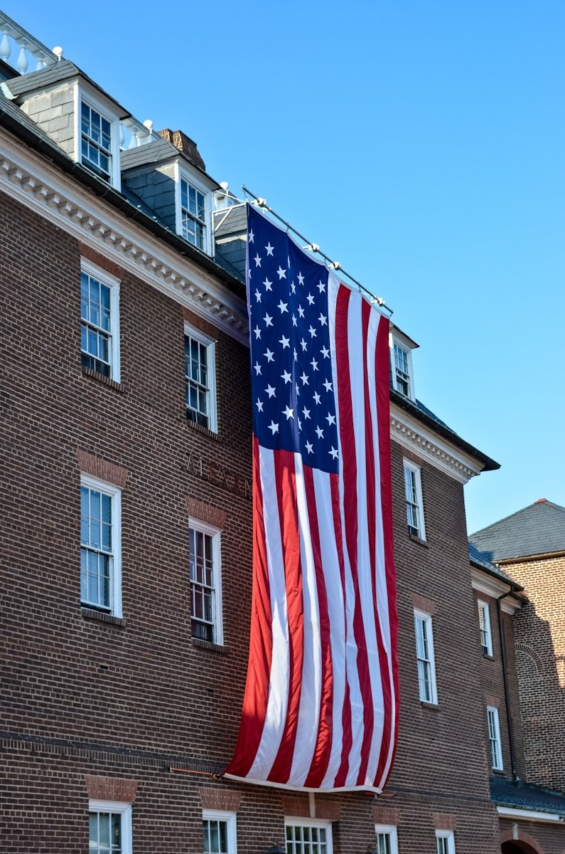 us a flag near brown concrete building during daytime